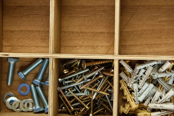 Wooden box for metal bolts, screws and nuts close up — Stock Photo, Image