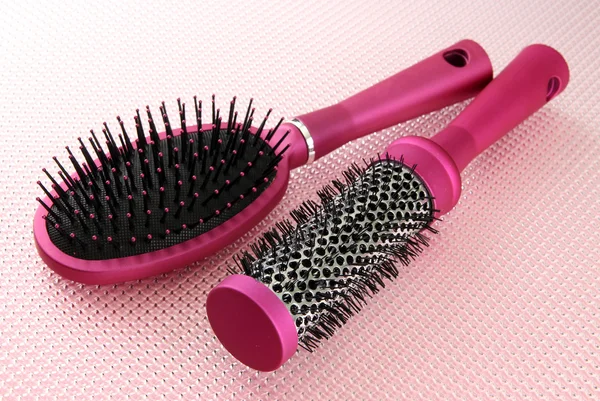 Comb brushes on pink background — Stock Photo, Image