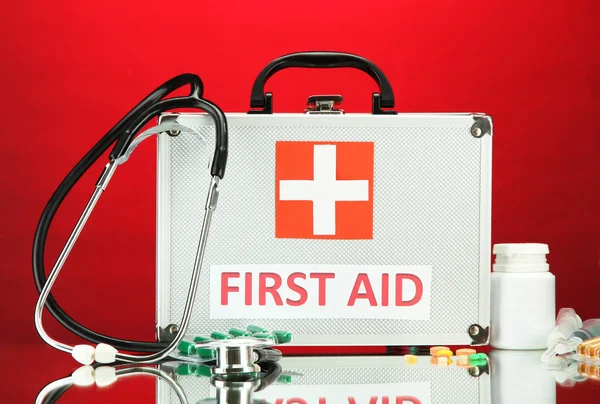 First aid box, on red background — Stock Photo, Image