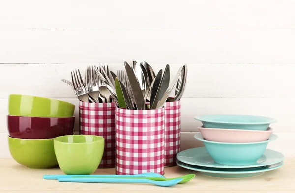 Cups, bowls nd other utensils in metal containers isolated on light background — Stok fotoğraf