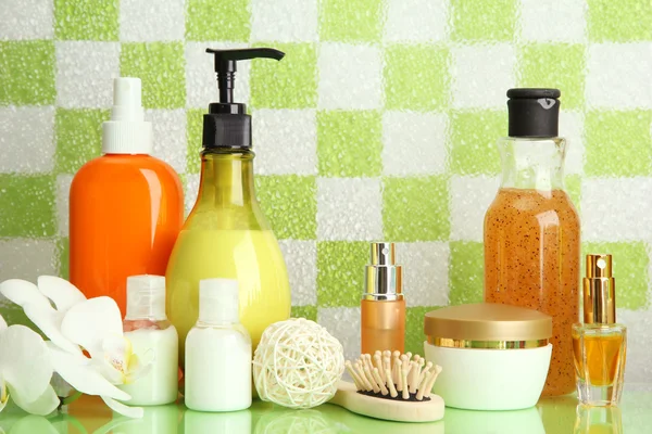 Bath accessories on shelf in bathroom on green tile wall background — Stock Photo, Image