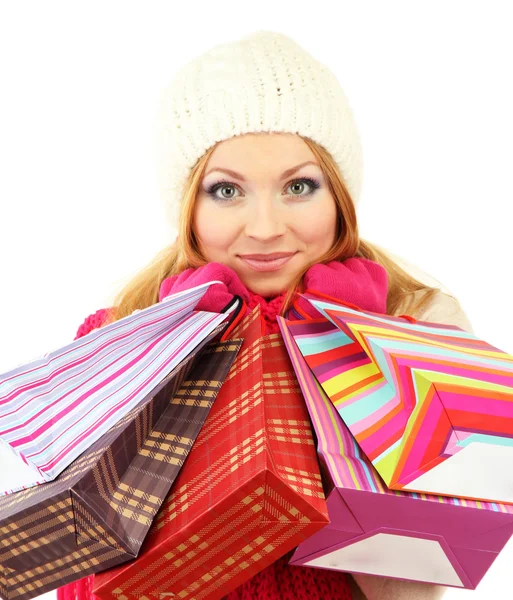 Attraente giovane donna con un sacco di borse della spesa, isolato su bianco — Foto Stock