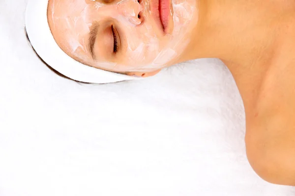 Young woman with creamy facial mask — Stock Photo, Image