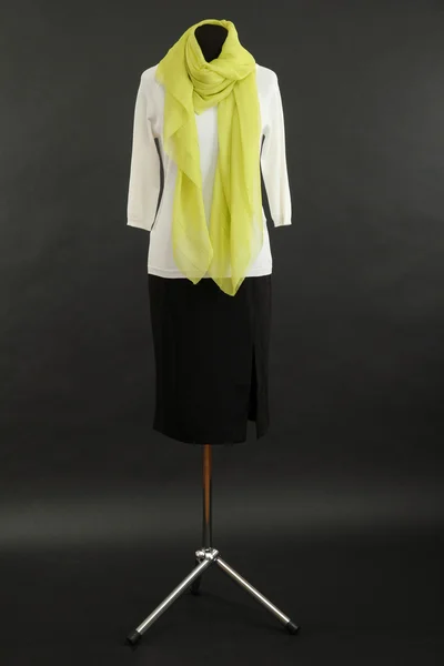 White blouse, black skirt and green scarf on mannequin on black background — Stock Photo, Image