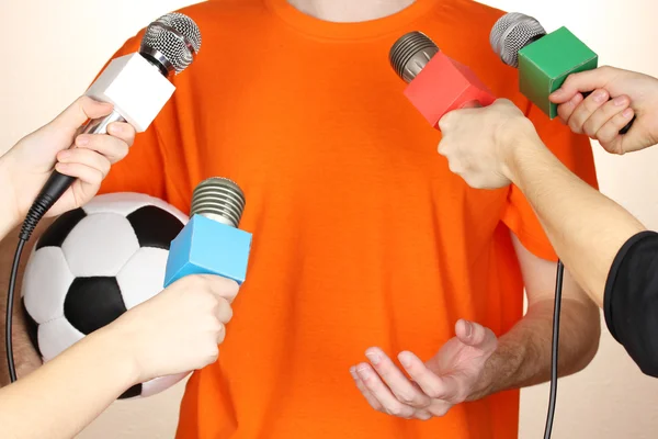 Conference meeting microphones and footballer — Stock Photo, Image