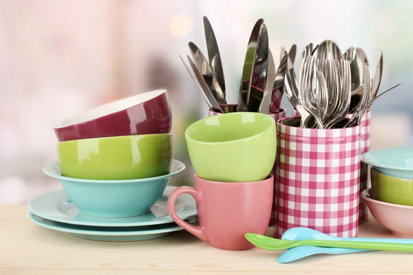 Cups, bowls nd other utensils in metal containers isolated on light background — Stockfoto