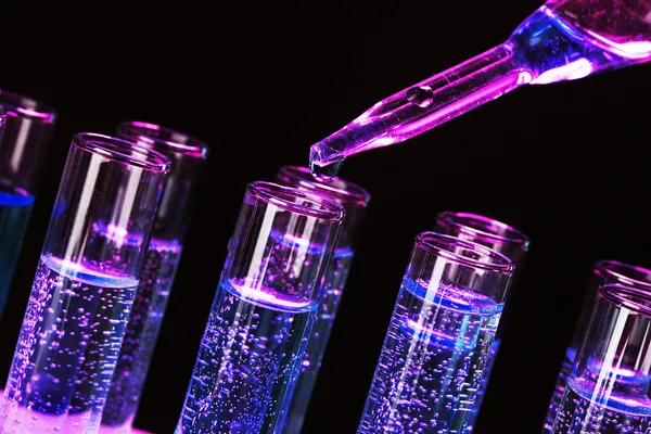 Test-tubes with liquid on black background — Stock Photo, Image