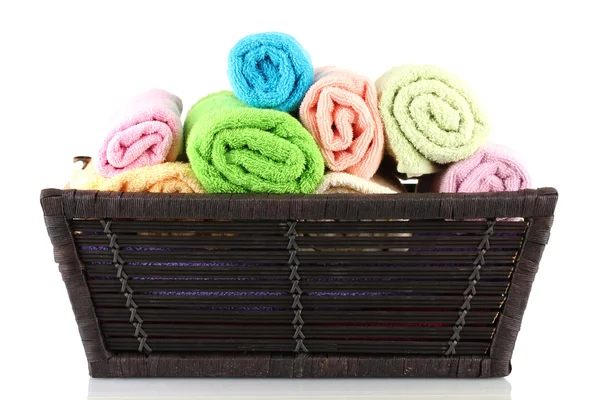 Colorful towels in basket isolated on white — Stock Photo, Image