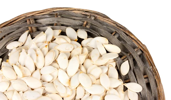 Pumpkin seeds on wicker mat, isolated on the white — Stock Photo, Image