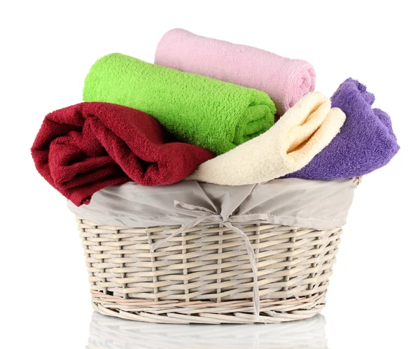 Colorful towels in basket isolated on white — Stock Photo, Image