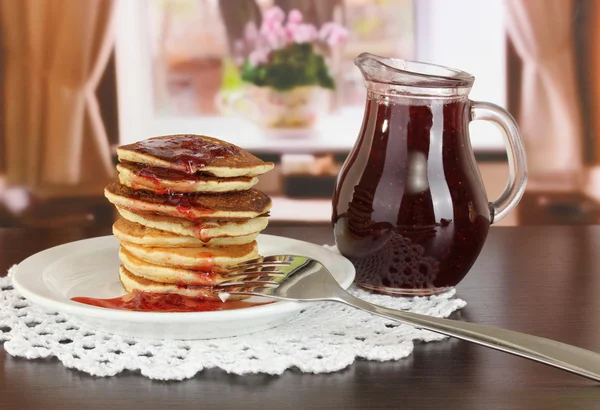 Sladké palačinky na desce s jam na stole v pokoji — Stock fotografie