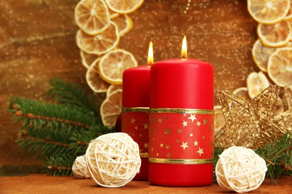 Two candles and christmas decorations, on golden background Royalty Free Stock Photos