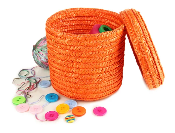 Orange wicker basket with accessories for needlework isolated on white — Stock Photo, Image