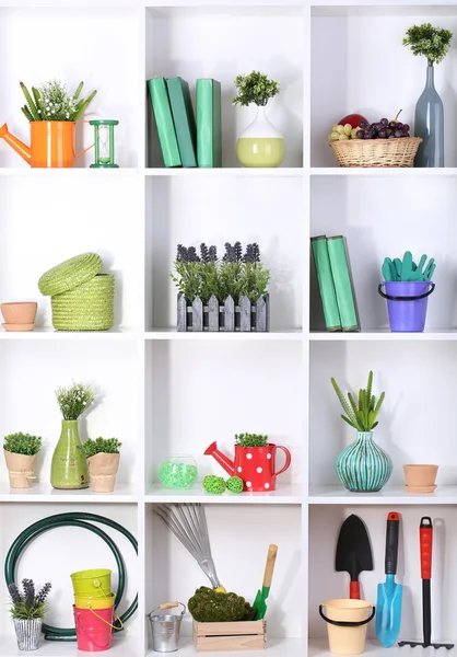 Beautiful white shelves with different gardening related objects — Stock Photo, Image