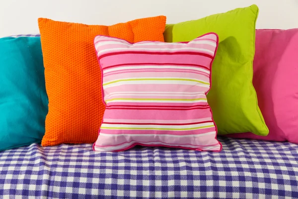 Colorful pillows on couch isolated on white — Stock Photo, Image