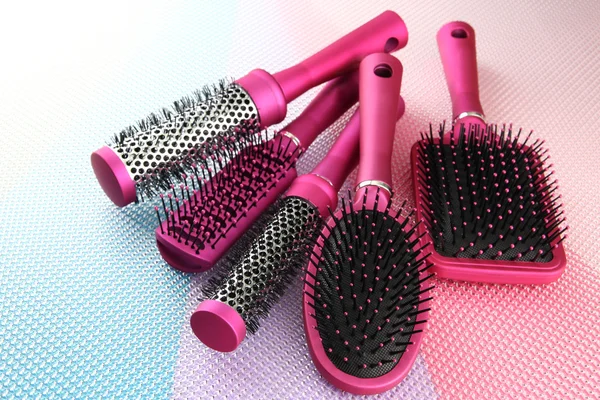 Comb brushes on bright background — Zdjęcie stockowe