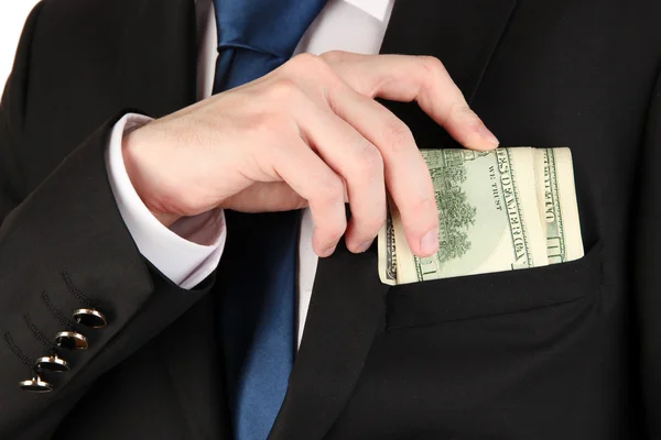 Ділова людина ховає гроші в кишені ізольовані на білому — стокове фото