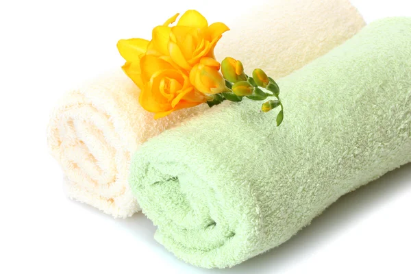 Colorful towels and flowers isolated on white Royalty Free Stock Photos