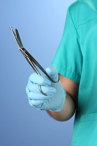 Doctor with medical instruments, on blue background