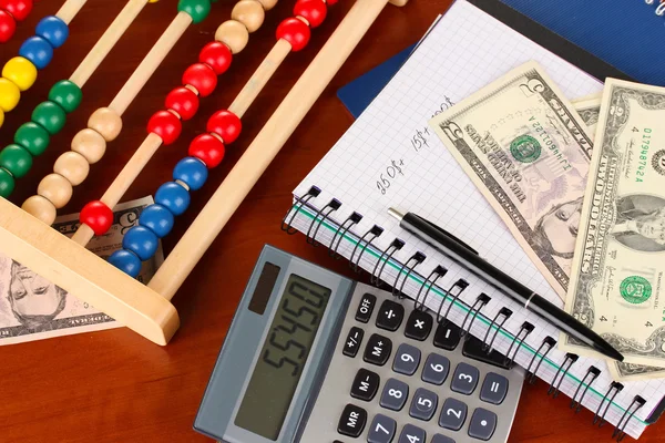 Bright wooden abacus and calculator. Conceptual photo of old and modern business — Stock Photo, Image