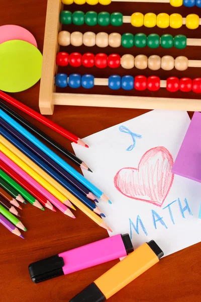 Toy abacus, note paper, pencils on bright background — Stock Photo, Image