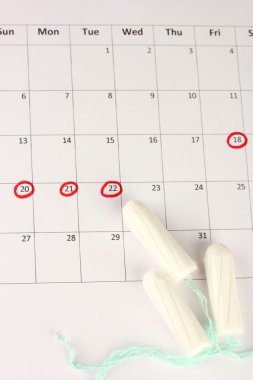 menstruation calendar with cotton tampons, close-up clipart
