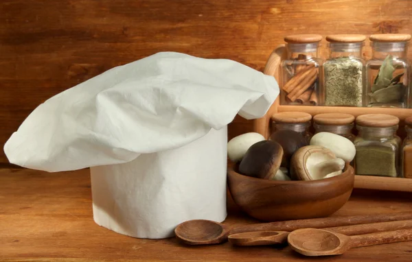 Composition with chef's hat on wooden background — Stock Photo, Image