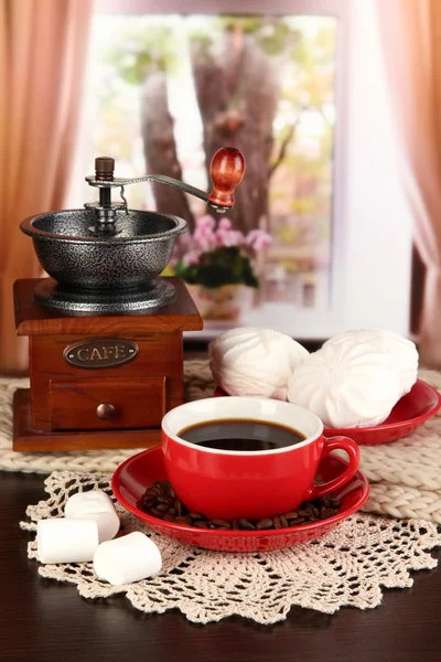 Cup of coffee with scarf and coffee mill on table in room — Stock Photo, Image