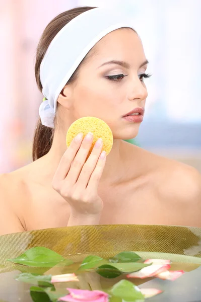 Young woman washing her face. Conceptual photo: make-up remover — Stock Photo, Image