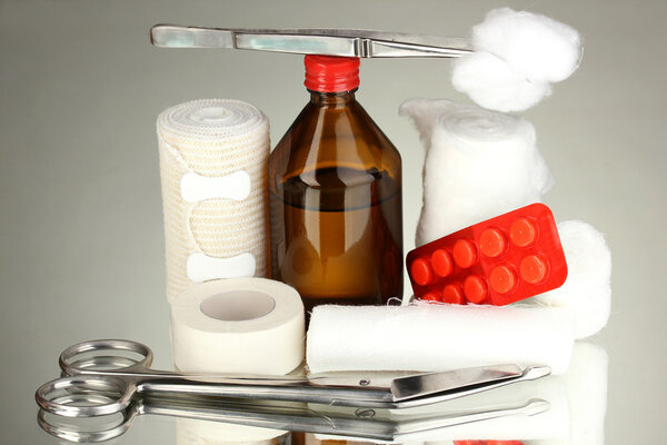 First aid kit for bandaging on grey background