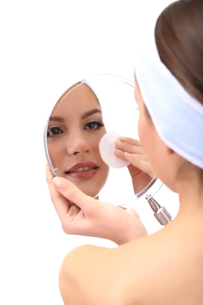 Young woman cleansing her face, isolated on white — Stock Photo, Image