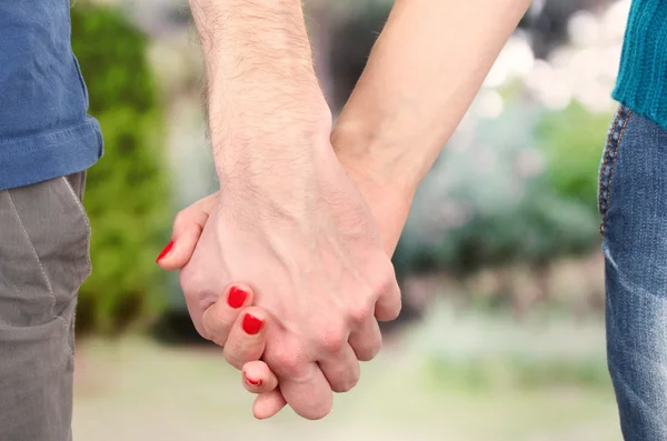 Two hands over green nature park — Stock Photo, Image