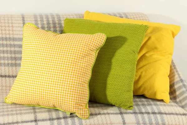 Colorful pillows on couch isolated on white — Stock Photo, Image