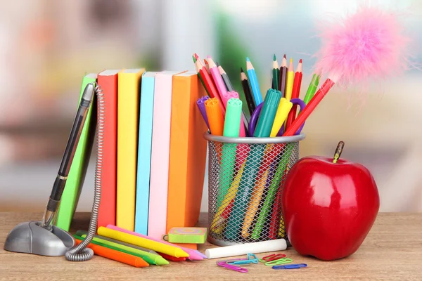 School supplies with apple on wooden table — Stock Photo, Image