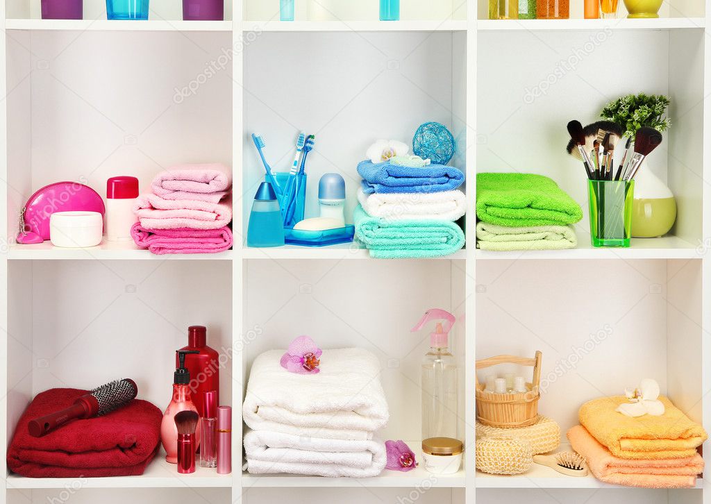 Bath accessories on shelfs in bathroom