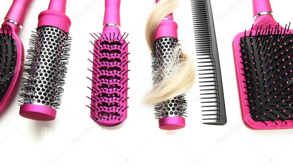 Comb brushes with hair, isolated on white