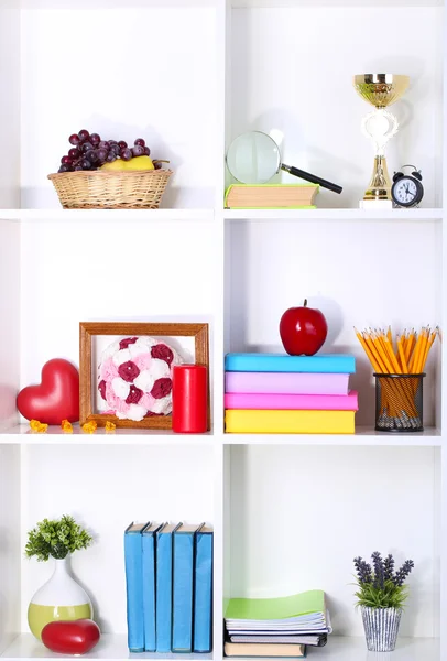 Beautiful white shelves with different home related objects — Stock Photo, Image