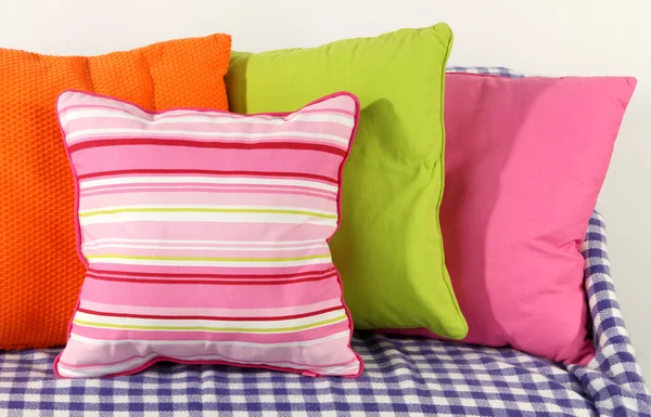 Colorful pillows on couch isolated on white — Stock Photo, Image