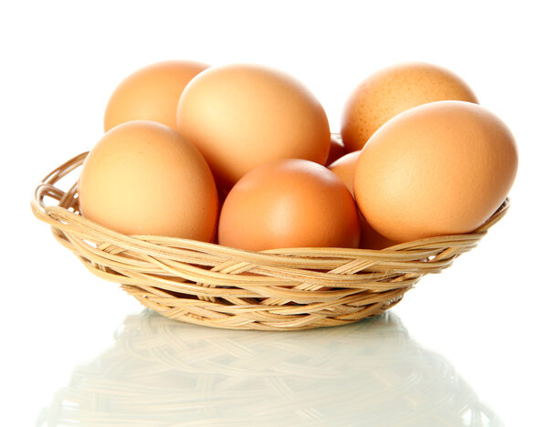 Many eggs in basket isolated on white
