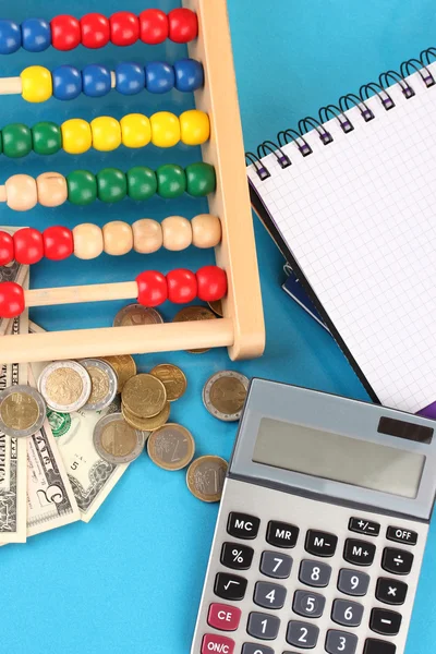 Bright wooden abacus and calculator. Conceptual photo of old and modern business — Stock Photo, Image