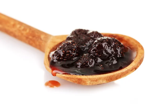 Tasty berry jam in wooden spoon, isolated on white — Stock Photo, Image