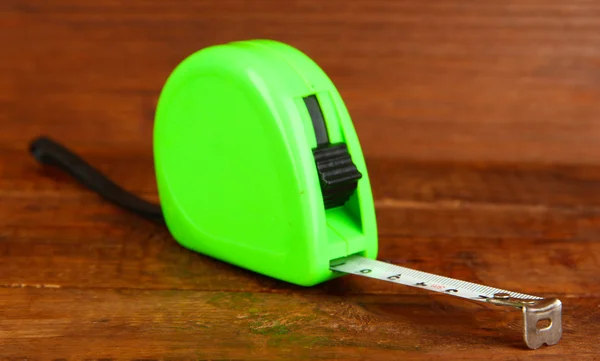 Tape measure on wooden background — Stock Photo, Image