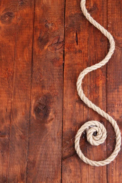 Frame composed of rope on wooden background — Stock Photo, Image