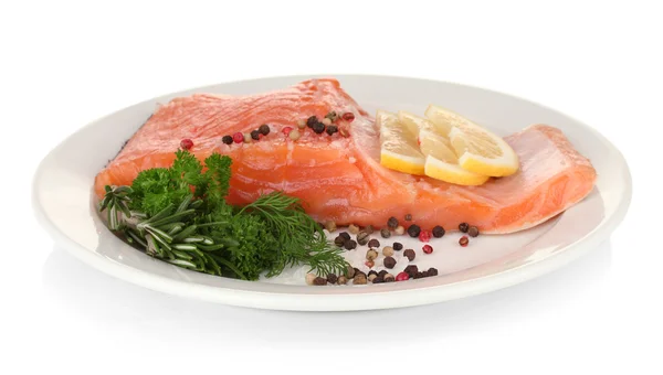 Fresh salmon fillet with herbals and lemon slices on plate, isolated on white — Stock Photo, Image