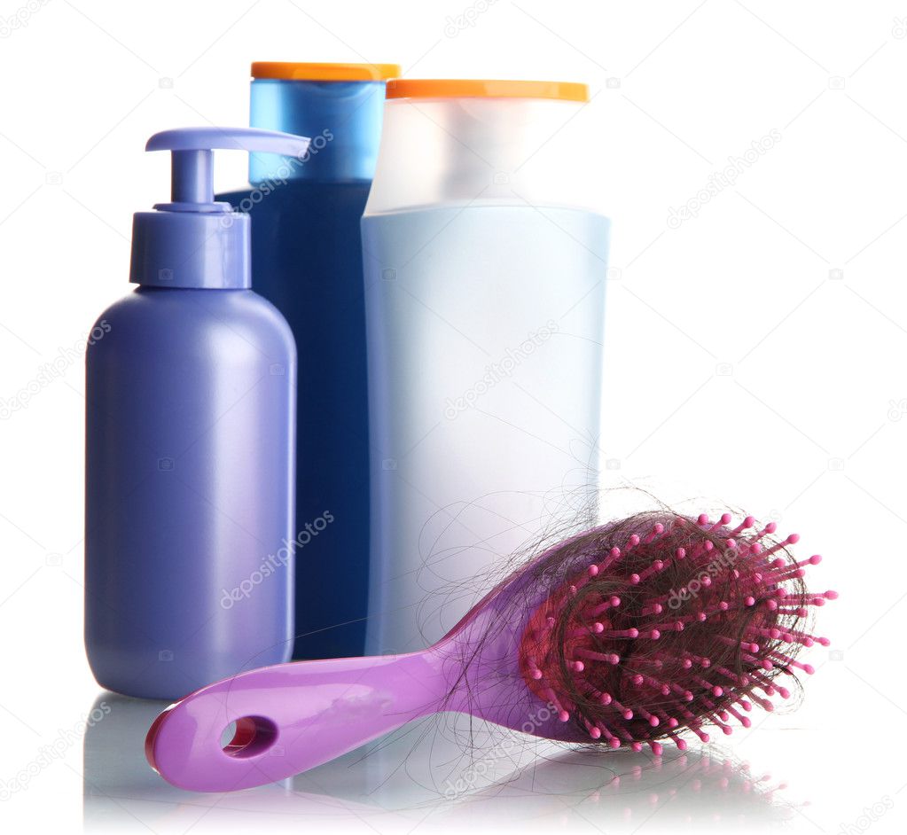 comb brush with lost hair and cosmetics bottles, isolated on white