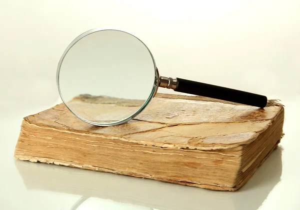 Magnifying glass and book isolated on white — Stock Photo, Image