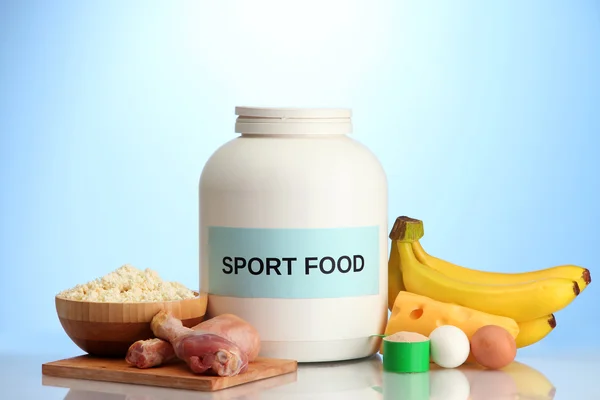 Jar of protein powder and food with protein, on blue background — Stock Photo, Image