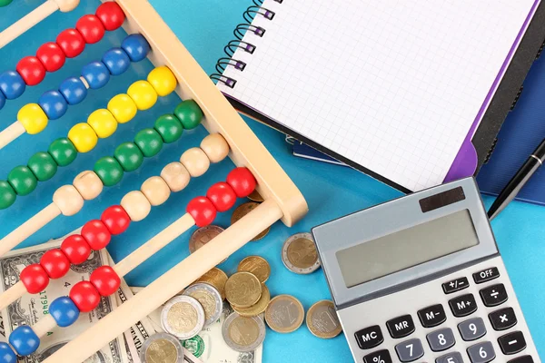 Bright wooden abacus and calculator. Conceptual photo of old and modern business — Stock Photo, Image