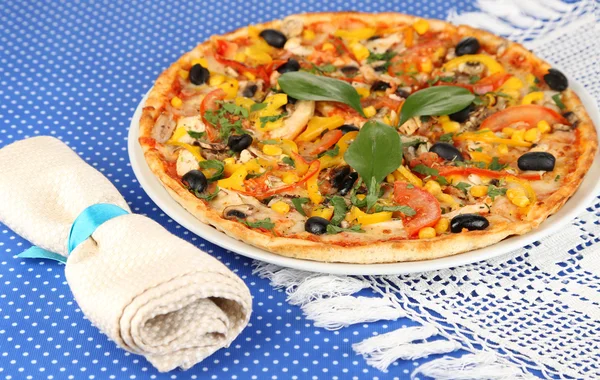 Pizza saborosa na toalha de mesa azul close-up — Fotografia de Stock