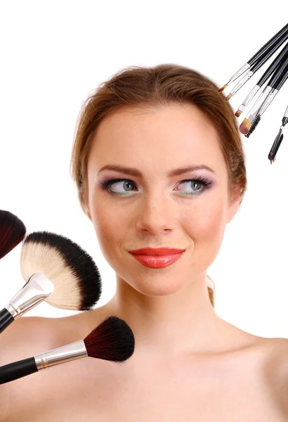 Portrait of beautiful woman with make-up brushes, isolated on white Stock Image